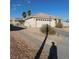 Charming single story home with long driveway, desert landscaping, attached garage, and tile roof at 1214 Emerald Stone Ave, North Las Vegas, NV 89081