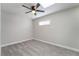 Carpeted bedroom with a ceiling fan and a sunlit window, perfect for relaxation at 142 Ivy St, Henderson, NV 89015