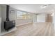 Bright living room with wood-look floors, a fireplace, and sliding glass doors at 142 Ivy St, Henderson, NV 89015