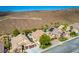 Aerial view of a house with a pool in a desert residential neighborhood at 2012 Poetry Ave, Henderson, NV 89052