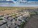 Overhead view of a neighborhood, with a mix of homes, desert landscape and clear blue sky at 2012 Poetry Ave, Henderson, NV 89052