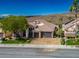 Aerial view showcasing a well-manicured lawn and a spacious three-car garage at 2012 Poetry Ave, Henderson, NV 89052