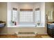 Bright bathroom featuring a large soaking tub with a set of large windows at 2012 Poetry Ave, Henderson, NV 89052