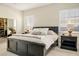 Bedroom featuring carpet flooring, a large bed, windows with shutters and two nightstands at 2012 Poetry Ave, Henderson, NV 89052