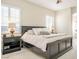 Bedroom featuring carpet flooring, a large bed, windows with shutters and two nightstands at 2012 Poetry Ave, Henderson, NV 89052