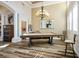 Elegant billiard room featuring a pool table, chandelier, and beautiful flooring for entertaining guests at 2012 Poetry Ave, Henderson, NV 89052