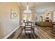 Open-concept dining room leading to the living room with hardwood floors and natural light at 2012 Poetry Ave, Henderson, NV 89052