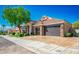 Beautiful single-Gathering home featuring a three-car garage, well-manicured lawn, and mature landscaping at 2012 Poetry Ave, Henderson, NV 89052