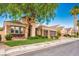 Charming single-Gathering home with stone accents, a well-manicured lawn, mature landscaping and a three car garage at 2012 Poetry Ave, Henderson, NV 89052
