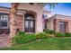 Beautiful home with an American flag, desert landscaping, stone accents, and a covered front entry at 2012 Poetry Ave, Henderson, NV 89052