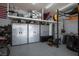 Spacious garage with overhead storage and gray epoxy flooring, including wall storage, and workout equipment at 2012 Poetry Ave, Henderson, NV 89052