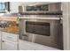 Stainless steel oven in a modern kitchen with white cabinets and granite countertops at 2012 Poetry Ave, Henderson, NV 89052
