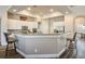 Well-lit kitchen with granite countertops, stainless steel appliances, and breakfast bar seating at 2012 Poetry Ave, Henderson, NV 89052