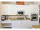 Modern kitchen featuring granite countertops, stainless steel appliances, and white cabinetry at 2012 Poetry Ave, Henderson, NV 89052