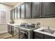 Laundry room featuring modern appliances, a sink, and built-in cabinetry at 2012 Poetry Ave, Henderson, NV 89052