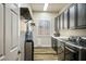 Laundry room with modern washer and dryer, window and overhead shelving at 2012 Poetry Ave, Henderson, NV 89052