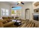 Comfortable living room with a fireplace, natural light, and hardwood floors at 2012 Poetry Ave, Henderson, NV 89052