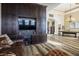 Elegant living room featuring a custom built-in entertainment center, a pool table, and stylish hardwood floors at 2012 Poetry Ave, Henderson, NV 89052
