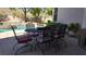 Outdoor patio furniture with pool view at 2012 Poetry Ave, Henderson, NV 89052