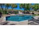 Inviting pool with a waterfall feature and tiled coping at 2012 Poetry Ave, Henderson, NV 89052