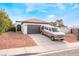 Single story home with attached garage and desert landscaping at 2258 Ray Kanel Dr, Las Vegas, NV 89156