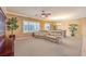 Living room featuring neutral walls, carpet, and a large sofa with views into dining area at 2277 Canyonville Dr, Henderson, NV 89044