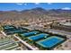 Aerial view of the community tennis courts in a residential neighborhood with mountains in the distance at 2277 Canyonville Dr, Henderson, NV 89044