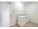 Laundry room with washer, dryer, overhead shelving and access door at 2301 Bahama Point Ave, North Las Vegas, NV 89031