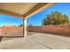 This patio has a concrete floor and faces a rock covered yard with a tall brick wall at 2301 Bahama Point Ave, North Las Vegas, NV 89031