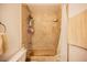 Cozy bathroom features tiled shower/bathtub combo and convenient storage shelving at 271 Greenbriar Townhouse Way, Las Vegas, NV 89121