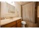 Bathroom featuring a single sink vanity and shower with a shower curtain at 271 Greenbriar Townhouse Way, Las Vegas, NV 89121