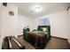 Comfortable bedroom features wood-look floors, a large window, and ample closet space at 271 Greenbriar Townhouse Way, Las Vegas, NV 89121