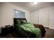 Cozy bedroom with wood-look floors, a large window, and ample closet space at 271 Greenbriar Townhouse Way, Las Vegas, NV 89121