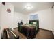 Bedroom featuring hardwood floors, a cozy bed with decorative pillows, and a window with horizontal blinds at 271 Greenbriar Townhouse Way, Las Vegas, NV 89121