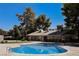 A refreshing community pool invites relaxation under a clear blue sky, surrounded by lush greenery at 271 Greenbriar Townhouse Way, Las Vegas, NV 89121