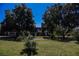 A lush green lawn and mature trees create a welcoming view of the community at 271 Greenbriar Townhouse Way, Las Vegas, NV 89121