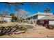 Well-maintained front lawn and sidewalk in front of condo units with mature trees at 271 Greenbriar Townhouse Way, Las Vegas, NV 89121