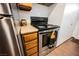 Close up of a black electric range and stainless steel refrigerator in the kitchen at 271 Greenbriar Townhouse Way, Las Vegas, NV 89121
