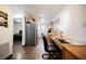 Eat-in kitchen includes gray refrigerator, wood cabinets, wood floors, and a built in desk at 271 Greenbriar Townhouse Way, Las Vegas, NV 89121