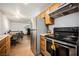 View of kitchen and adjacent space with stainless steel appliances and wooden cabinets at 271 Greenbriar Townhouse Way, Las Vegas, NV 89121
