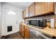 Kitchen counter with a microwave and door that leads to the outside at 271 Greenbriar Townhouse Way, Las Vegas, NV 89121