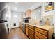 Well lit kitchen with wooden cabinets, stainless steel appliances, and a door leading to the outside at 271 Greenbriar Townhouse Way, Las Vegas, NV 89121