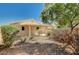 Exterior of home with covered patio and desert landscaping at 2717 El Milagro St, Las Vegas, NV 89108