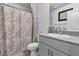 Clean bathroom with floral shower curtain and gray vanity at 2827 Blue Mosaic Ln # 3, Las Vegas, NV 89183