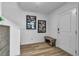 Bright and airy entryway with a bench and modern art at 2827 Blue Mosaic Ln # 3, Las Vegas, NV 89183