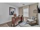 Bright home office with wood desk and comfortable seating at 2827 Blue Mosaic Ln # 3, Las Vegas, NV 89183