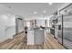 Spacious kitchen with gray cabinets, large island, stainless steel refrigerator, and adjacent dining area at 2827 Blue Mosaic Ln # 3, Las Vegas, NV 89183