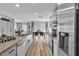 Bright, open kitchen features stainless appliances, granite counters, and a seamless flow into the dining and living areas at 2827 Blue Mosaic Ln # 3, Las Vegas, NV 89183