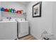 Laundry room with washer, dryer, and storage shelves at 2827 Blue Mosaic Ln # 3, Las Vegas, NV 89183