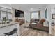 Open-concept living area with a large TV and comfortable seating at 2827 Blue Mosaic Ln # 3, Las Vegas, NV 89183